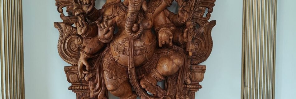 a wooden statue of a god in a room