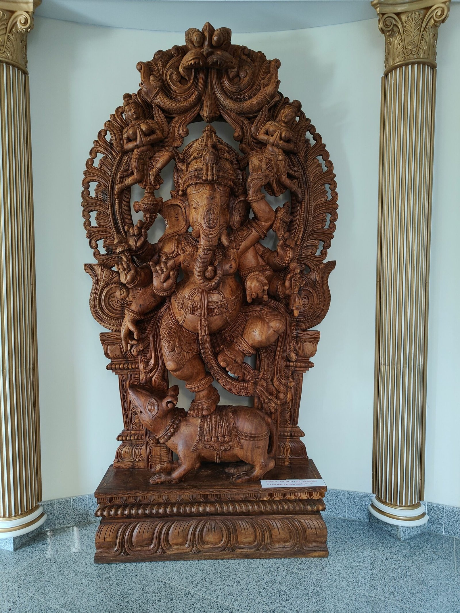 a wooden statue of a god in a room