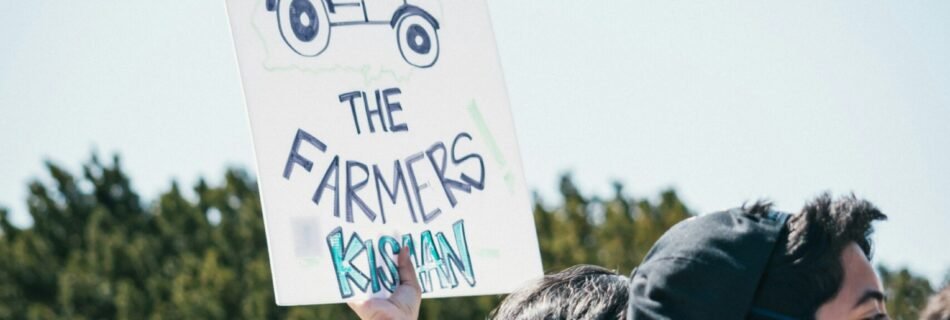 people standing and holding white and black banner during daytime