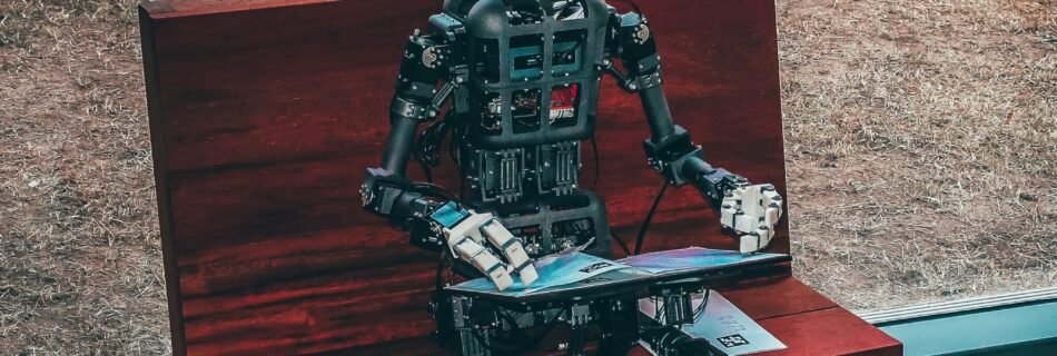 black and white robot toy on red wooden table