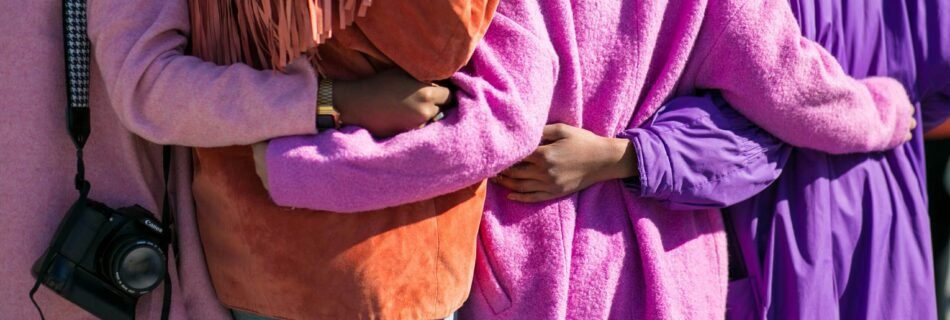 four person holding each others waist at daytime