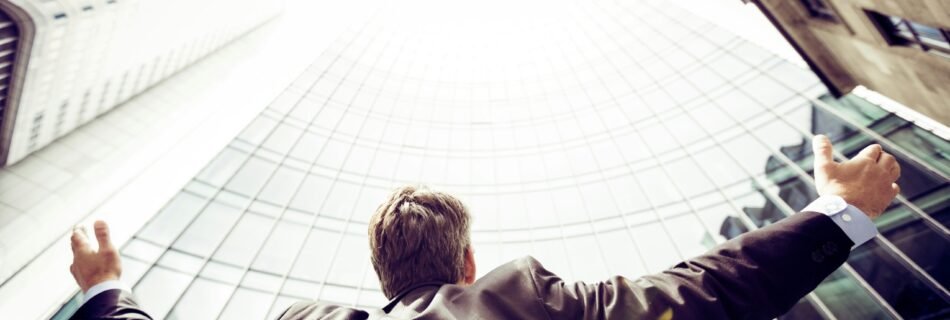 low-angle photography of man in the middle of buidligns