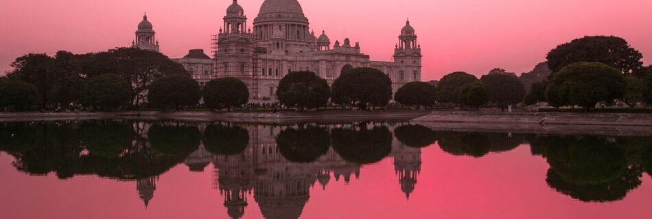 white concrete castle near body of water